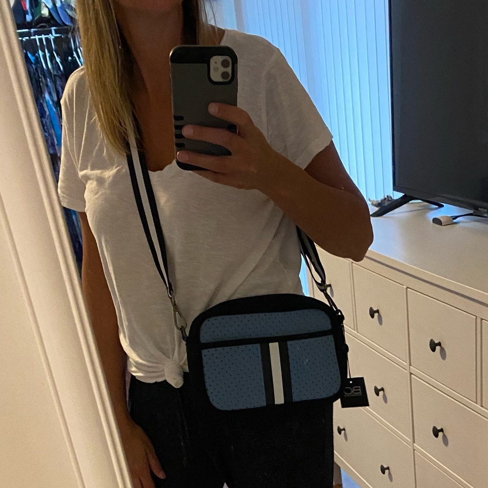 Neoprene compact crossbody bag with hidden front zipper compartment
